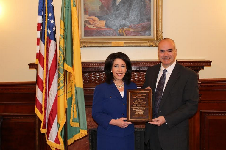 County Executive Cheryl Dinolfo accepts the APWA New York State Project of the Year Award with Airport Director Andy Moore.